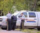 RCMP officers take down information  outside a residence on Spruce